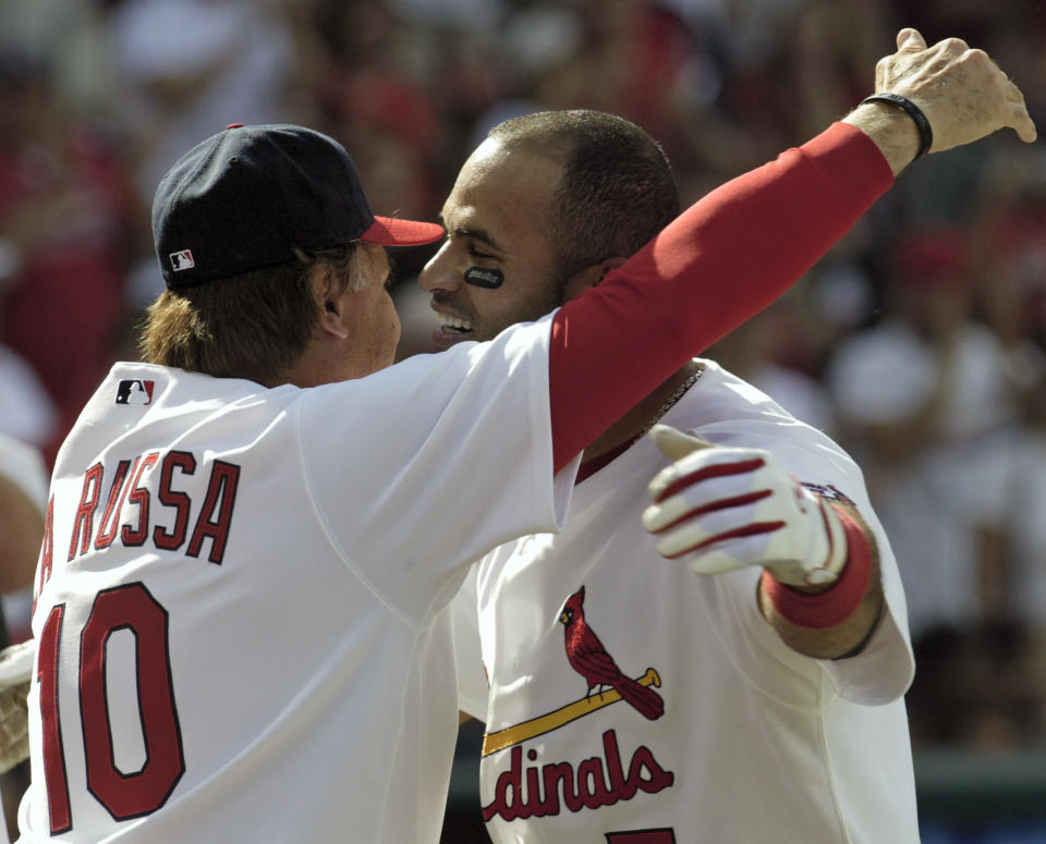 St. Louis Cardinals' Albert Pujols, right, embraces manager Tony La Russa after hitting a two-run walk-off home run in the ninth inning against the Cincinnati Reds in their baseball game Sunday, April 16, 2006, at Busch Stadium in St. Louis. Pujols hit three home runs as the Cardinals beat the Reds 8-7. (AP Photo/Tom Gannam)