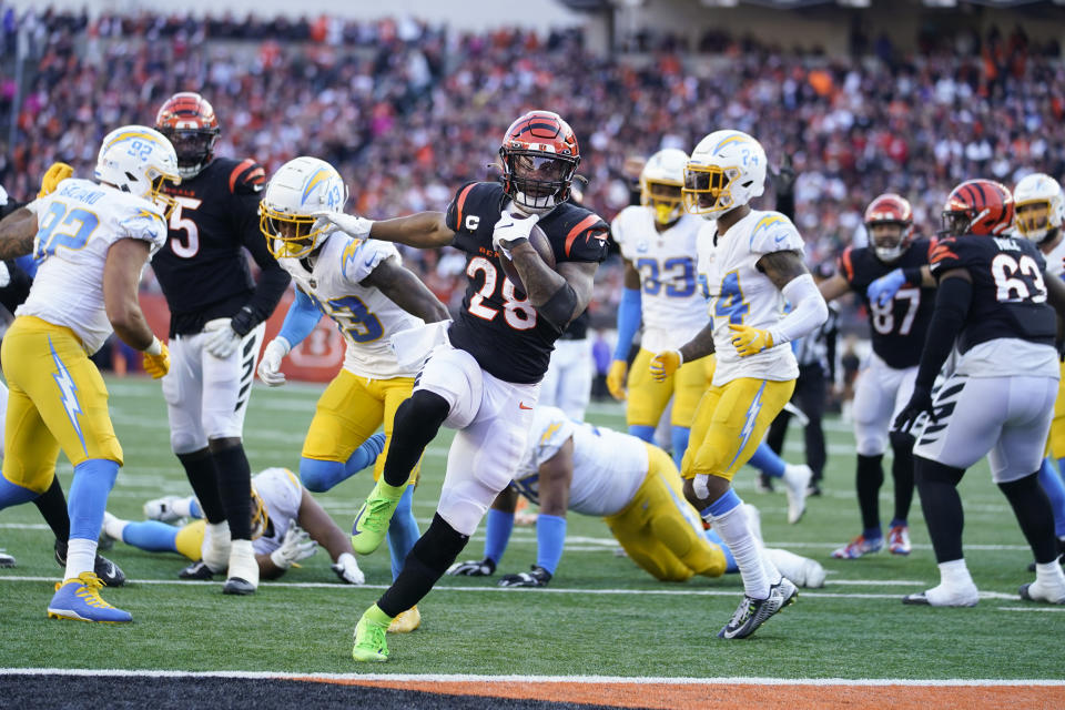 Cincinnati Bengals' Joe Mixon (28) runs in for a touchdown during the second half of an NFL football game against the Los Angeles Chargers, Sunday, Dec. 5, 2021, in Cincinnati. (AP Photo/Michael Conroy)