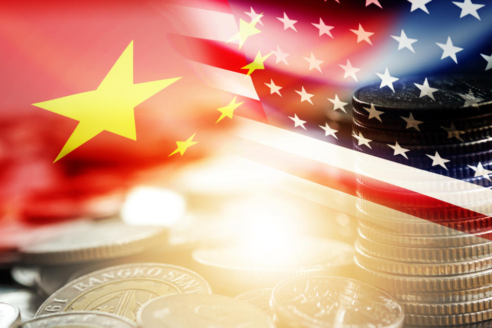 USA and China flag on coins stacking .It is symbol of economic tariffs trade war and tax barrier between United States of America and China.