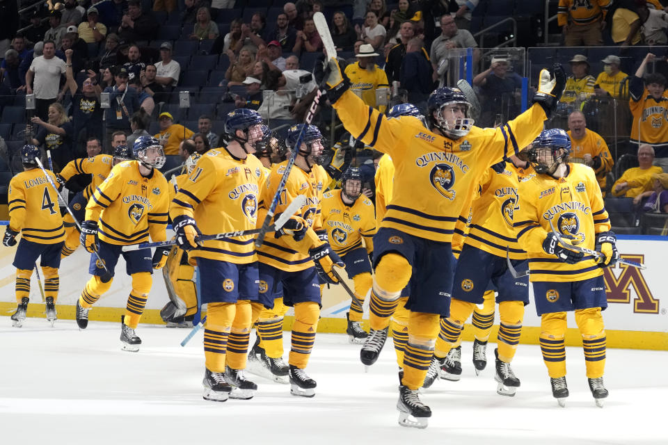 Quinnipiac players celebrate after the team defeated Michigan during an NCAA semifinal game in the Frozen Four college hockey tournament Thursday, April 6, 2023, in Tampa, Fla. (AP Photo/Chris O'Meara)