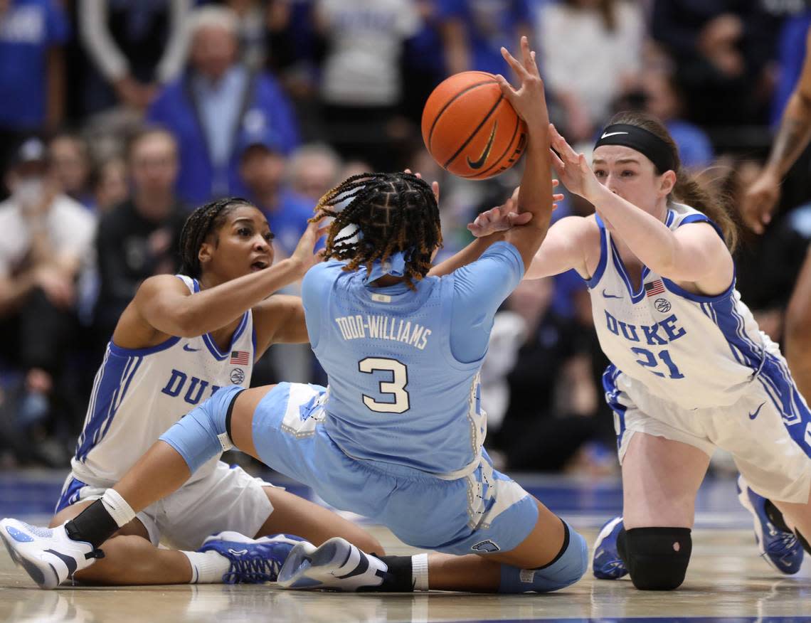 North Carolina’s Kennedy Todd-Williams looks to pass under pressure from Duke’s Ashlon Jackson and Kennedy Brown during the first half of the Blue Devils’ regular season finale against North Carolina on Sunday, Feb. 26, 2023, at Cameron Indoor Stadium in Durham, N.C.