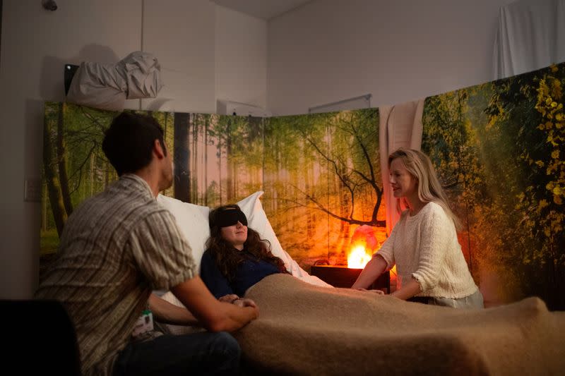 Dr Rosalind Watts is seen in a treatment room with therapists at Imperial College London's Hammersmith Hospital Campus in London