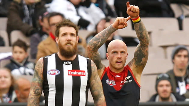 Melbourne's Nathan Jones points to an Aboriginal flag after kicking a goal.