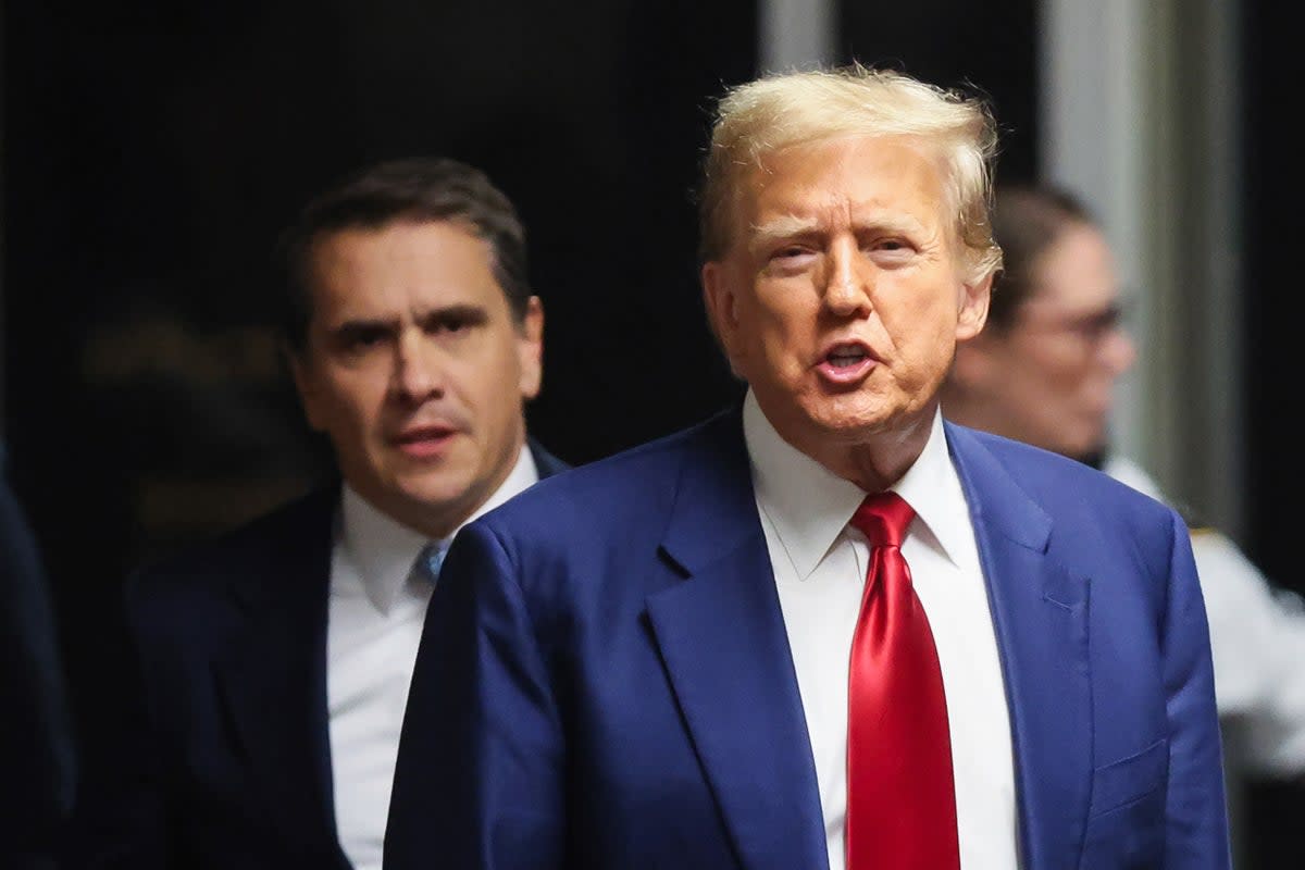 Donald Trump appears with his attorney Todd Blanche outside a Manhattan criminal courtroom on 25 March. (Getty Images)