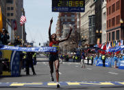 Rita Jeptoo, of Kenya, bereaks the tape to win the women's division of the 118th Boston Marathon Monday, April 21, 2014 in Boston. (AP Photo/Elise Amendola)