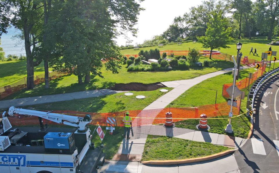 Work is done around a sinkhole at Big Bay Park on North Lake Drive in Whitefish Bay on Monday, June 10, 2024.