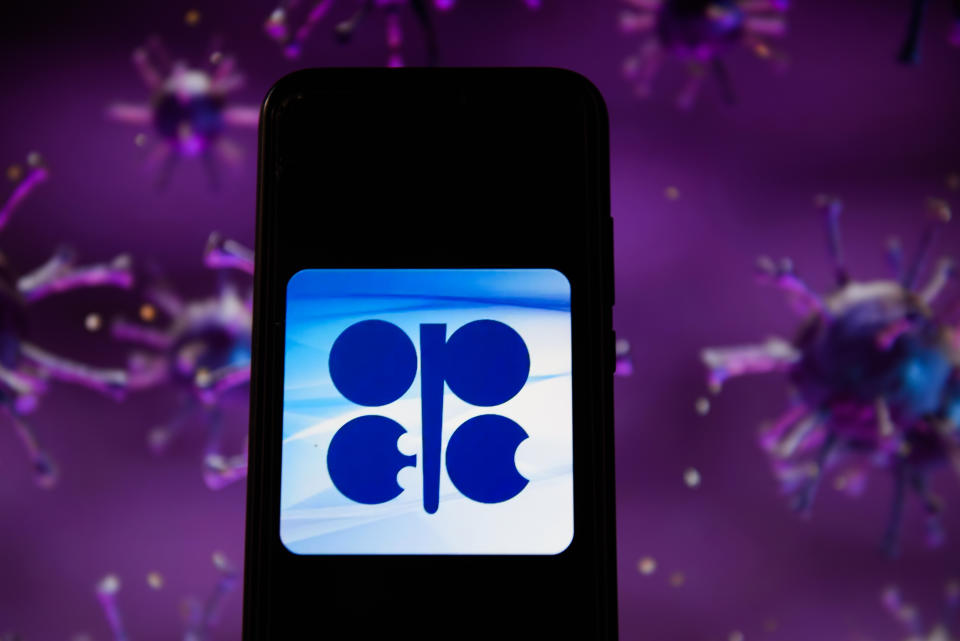 POLAND - 2020/04/28: In this photo illustration an OPEC logo displayed on a smartphone with a COVID 19 sample image in the background. (Photo Illustration by Omar Marques/SOPA Images/LightRocket via Getty Images)