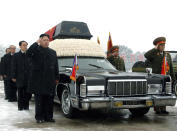 FILE - North Korea's next leader Kim Jong Un, fourth left, salutes beside the hearse carrying the body of his late father and North Korean leader Kim Jong Il during the funeral procession in Pyongyang, North Korea on Dec. 28, 2011. Escorting Kim Jong Un are, Jang Song Thaek, Kim Jong Il's brother-in-law and vice chairman of the National Defense Commission, third left, top propaganda official Kim Ki Nam, second left, Workers Party officials Choe Thae Bok, left partially hidden, and two military officers, Ri Yong Ho, vice marshal of the Korean People's Army, right, and People's Armed Forces Minister Kim Yong Chun. (AP Photo, File)