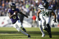 Baltimore Ravens quarterback Lamar Jackson (8) scrambles up field away from Seattle Seahawks linebacker Bobby Wagner (54) during the first half of an NFL football game, Sunday, Nov. 5, 2023, in Baltimore. (AP Photo/Nick Wass)