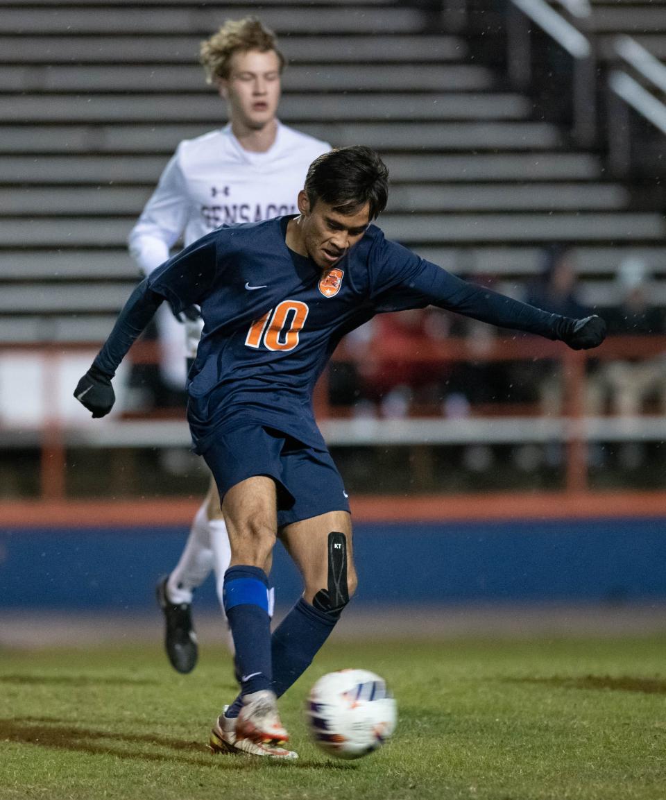 Griffin York (10) passes the ball during the Pensacola vs Escambia boys soccer game at Escambia High School in Pensacola on Monday, Dec. 19, 2022.