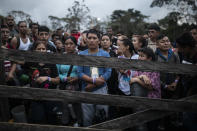 Migrants planning to start walking across the Darien Gap from Colombia to Panama in hopes of reaching the U.S. gather at the trailhead camp in Acandi, Colombia, Tuesday, May 9, 2023. The image was part of a series by Associated Press photographers Ivan Valencia, Eduardo Verdugo, Felix Marquez, Marco Ugarte Fernando Llano, Eric Gay, Gregory Bull and Christian Chavez that won the 2024 Pulitzer Prize for feature photography. (AP Photo/Ivan Valencia)