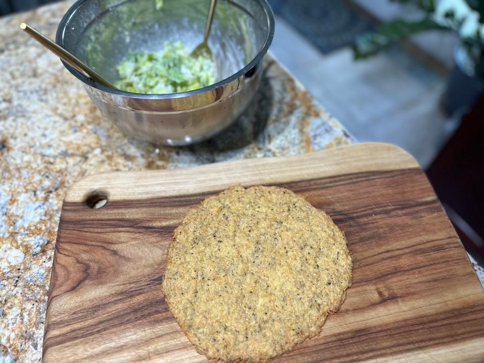 Chicken crust on cutting board next to bowl of prepared salad 