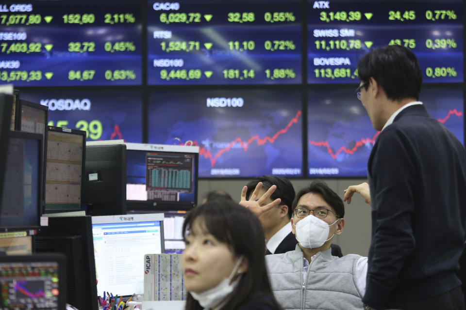 A currency trader wears a face mask at the foreign exchange dealing room of the KEB Hana Bank headquarters in Seoul, South Korea, Monday, Feb. 24, 2020. (AP Photo/Ahn Young-joon)