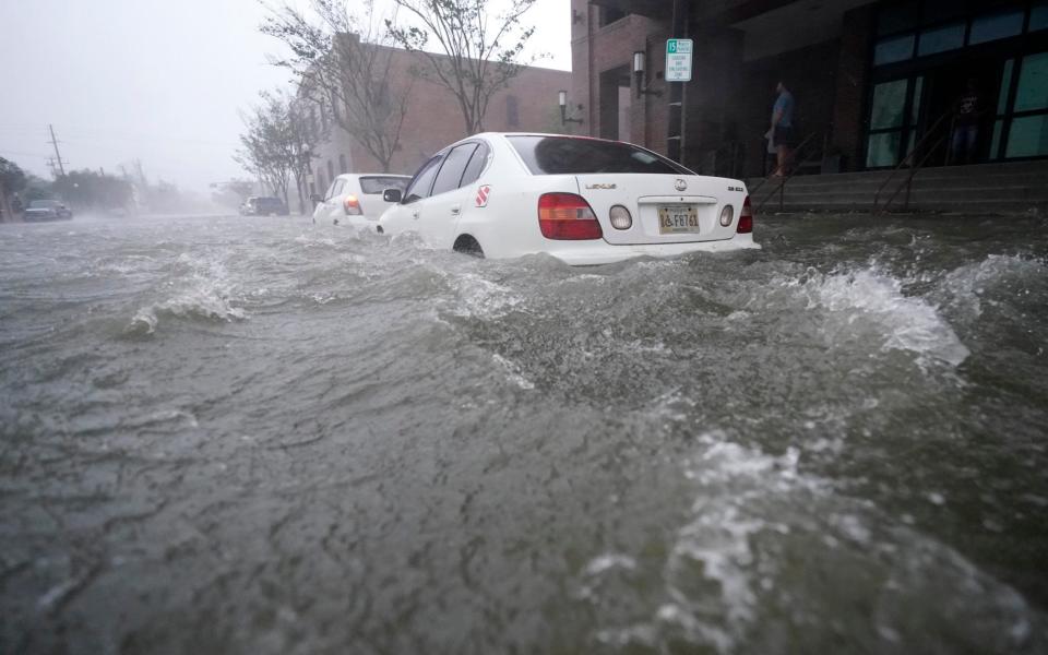 Flood waters surge through Pensacola, Florida, as 'feet' of rain falls - Gerald Herbert /AP