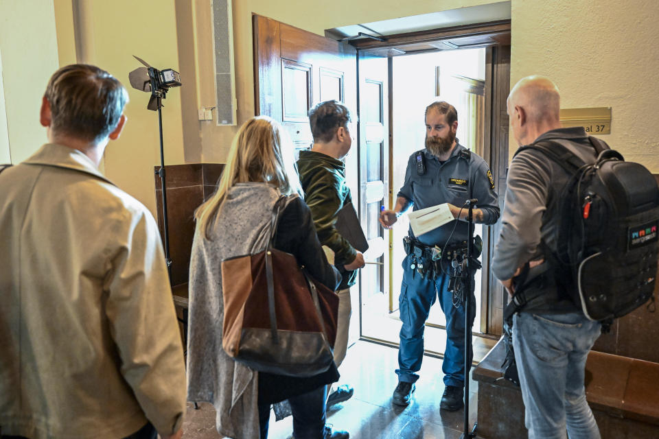 People wait outside a courtroom at the Stockholm District Court for the trial of a Russian-born Swedish citizen charged with collecting information for the Russian military intelligence service GRU for almost a decade, in Stockholm, Monday, Sept. 4, 2023. Sergey Skvortsov is accused of “gross illegal intelligence activities against Sweden and against a foreign power,” according to prosecutor Henrik Olin. (Jonas Ekstromer/TT News Agency via AP)