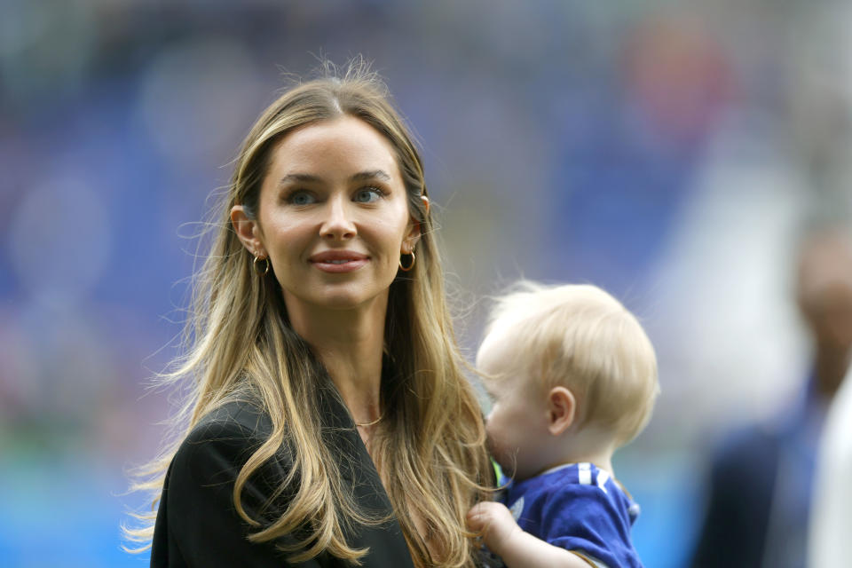 Kennedy Alexa, the partner of James Maddison of Leicester City, looks on with their son Leo following the Premier League match between Leicester City and Southampton at The King Power Stadium on May 22, 2022 in Leicester, England