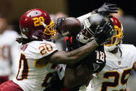 Atlanta Falcons wide receiver Calvin Ridley (18) makes the catch against Washington Football Team cornerback Bobby McCain (20) during the second half of an NFL football game, Sunday, Oct. 3, 2021, in Atlanta. (AP Photo/John Bazemore)