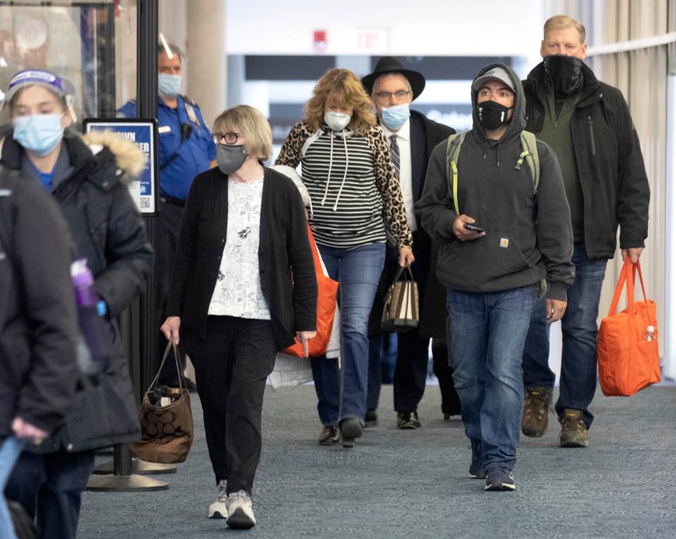 Passengers move through the terminal at Milwaukee Mitchell International Airport during this year's spring break travel season.