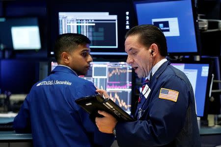 Traders work on the floor of the New York Stock Exchange (NYSE) in New York, U.S., July 5, 2017. REUTERS/Brendan McDermid