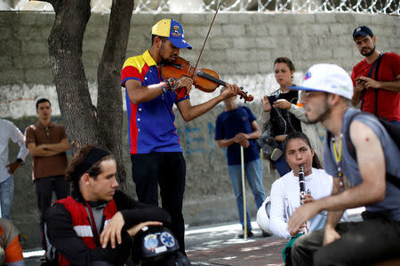 People play music during a strike called to protest against Venezuelan President Nicolas Maduro's government in Caracas, Venezuela July 26, 2017. REUTERS/Carlos Garcia Rawlins