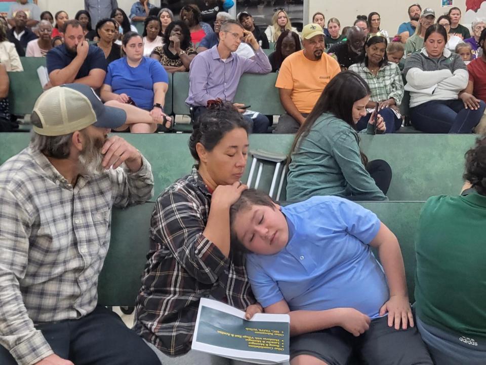Lisa Whipple strokes her son James Durden's head as the Gibson community raises their voices at Terrebonne Parish Superintendent Bubba Orgeron who wants to close Gibson Elementary School, Oct. 6.