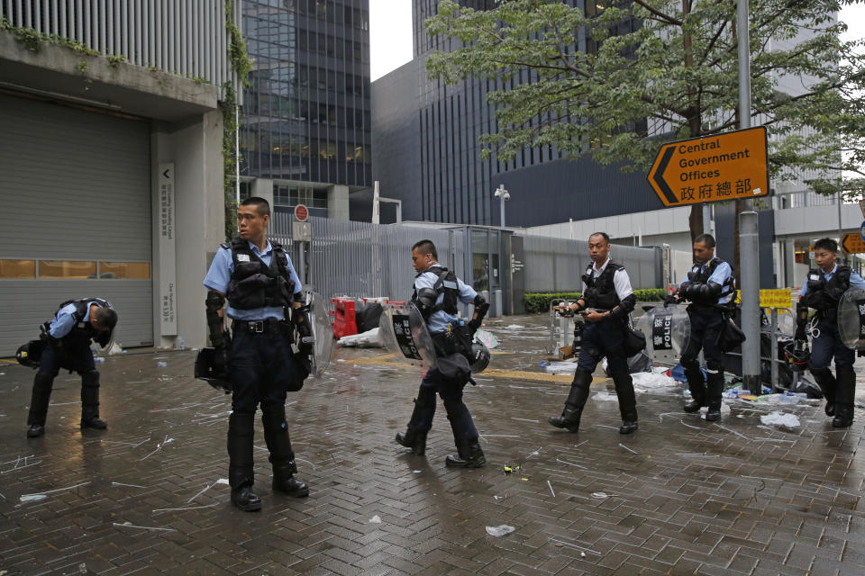 Riot police stand outside the Legislative Council in Hong Kong, Thursday, June 13, 2019. Traffic has been restored in the heart of Hong Kong a day after clashes between police and protesters who oppose legislation that would allow criminal suspects to be sent to mainland China for trial. (AP Photo/Kin Cheung)