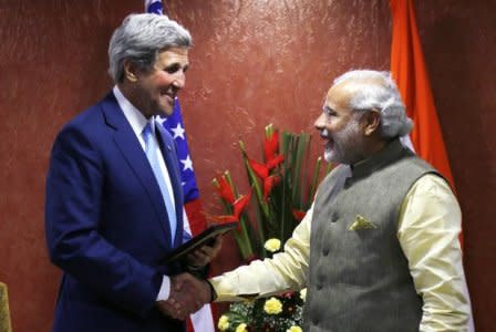 U.S. Secretary of State John Kerry (L) shakes hands with Indian Prime Minister Narendra Modi on the sidelines of the Vibrant Gujarat conference in Ahmedabad January 11, 2015. REUTERS/Rick Wilking