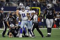 Dallas Cowboys linebacker Micah Parsons (11) celebrates sacking Las Vegas Raiders quarterback Derek Carr (4) as Brandon Parker (75) looks on in overtime of an NFL football game in Arlington, Texas, Thursday, Nov. 25, 2021. (AP Photo/Ron Jenkins)