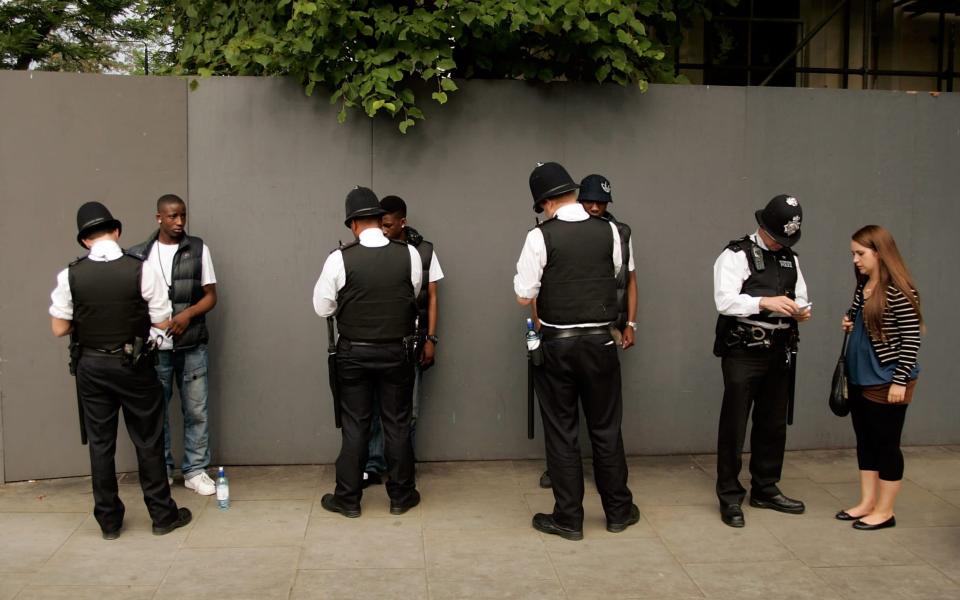 Police stop and search members of the public and assist another  - Jeremy O'Donnell /Getty Images Europe