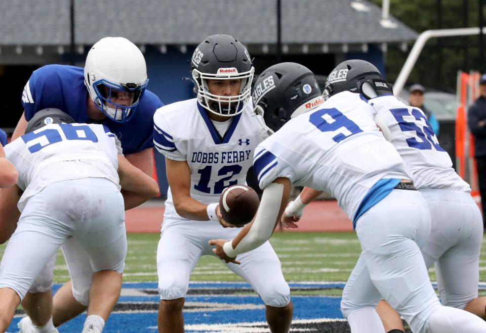 Dobbs Ferry quarterback Kevin Hartnett hands off the ball to Michael Guerrerio during their football game against Bronxville, at Bronxville High School, Sept. 23,. 2023. Dobbs Ferry beat Bronxville, 12-7.