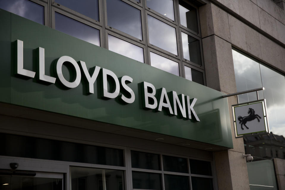 A logo is displayed outside a branch of Lloyds bank on the Strand in central London, Friday, Feb. 27, 2015.  London-based Lloyds Banking Group passed a milestone Friday in its recovery from the financial crisis, reporting an annual profit and announcing plans to pay a dividend for the first time since it was rescued by British taxpayers. The bank posted net income of 1.13 billion pounds ($1.7 billion) compared with a loss of 838 million pounds in 2013. The bank plans to pay a dividend of 0.75 pence per share, resulting in a total payout of 535 million pounds.  (AP Photo/Matt Dunham)