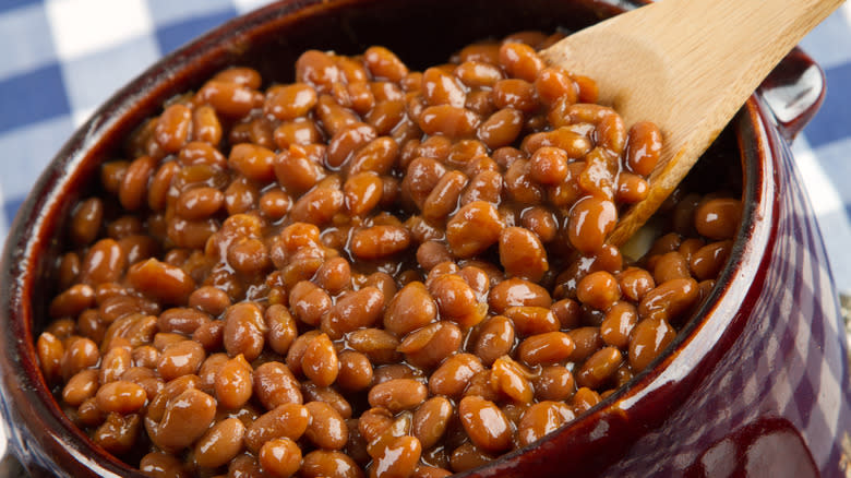 pot of beans with wooden spoon