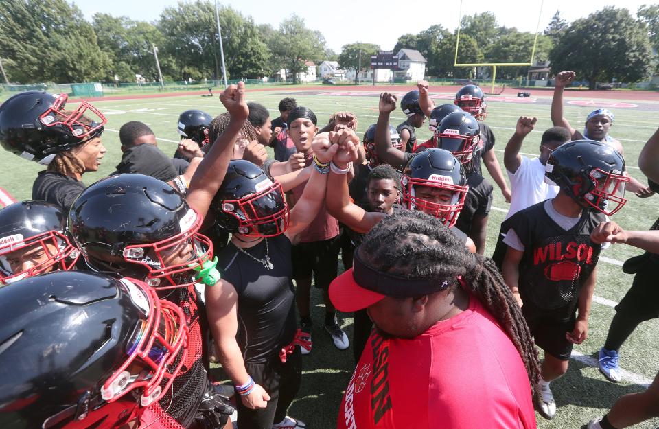 Wilson players come together on the first day of practice.