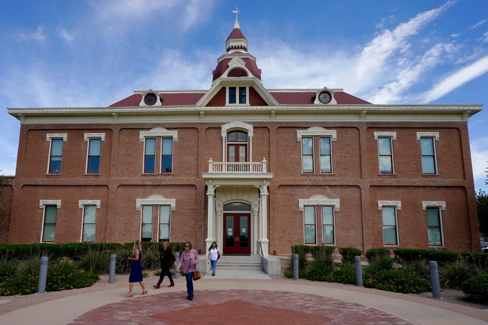 People exit the 1891 Pinal County Courthouse after a meeting with the Pinal County attorney and Board of Supervisors chairman to address election day ballot shortages in Pinal County on Aug. 3, 2022, in Florence.