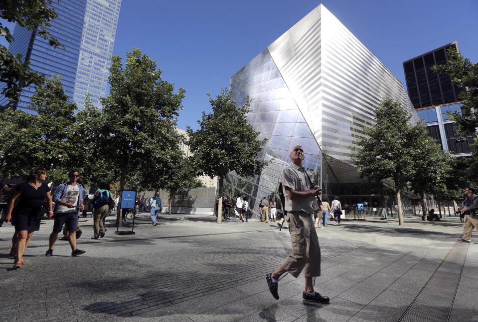 FILE - In this Sept. 6, 2013, file photo, a visitor to the National September 11 Memorial and Museum takes in the sight as he walks past the museum in New York. The long-awaited museum dedicated to the victims of the Sept. 11 terror attacks will open to the public at the World Trade Center site on May 21, officials announced Monday, March 24, 2014. (AP Photo/Mary Altaffer, File)