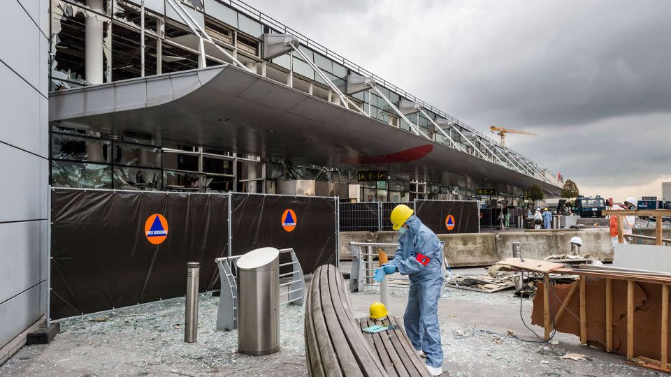 A forensics officer works in front of the damaged Zaventem Airport terminal in Brussels, March 23, 2016. - Geert Vanden Wijngaert/AP/FILE