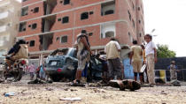 <p>Yemenis inspect the site of a suicide bombing that targeted young men seeking to join the army, in Aden, Yemen, on May 23, 2016. At least 45 Yemenis were reportedly killed in two suicide bombings. (EPA) </p>