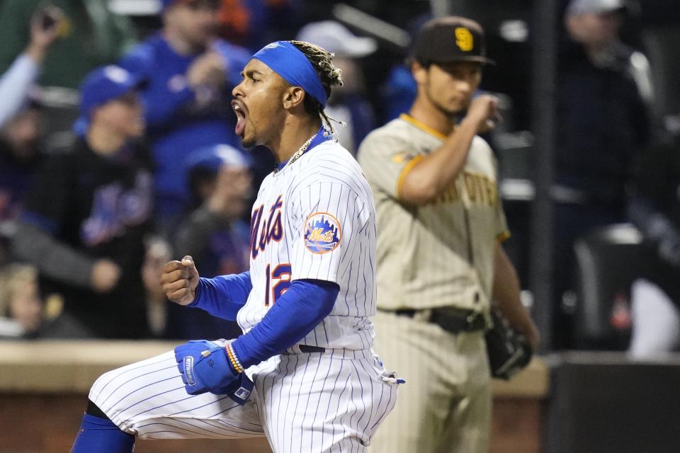 New York Mets' Francisco Lindor, left, celebrates after scoring on a two-run double by Jeff McNeil as San Diego Padres starting pitcher Yu Darvish, of Japan, reacts during the third inning of a baseball game Monday, April 10, 2023, in New York. (AP Photo/Frank Franklin II)