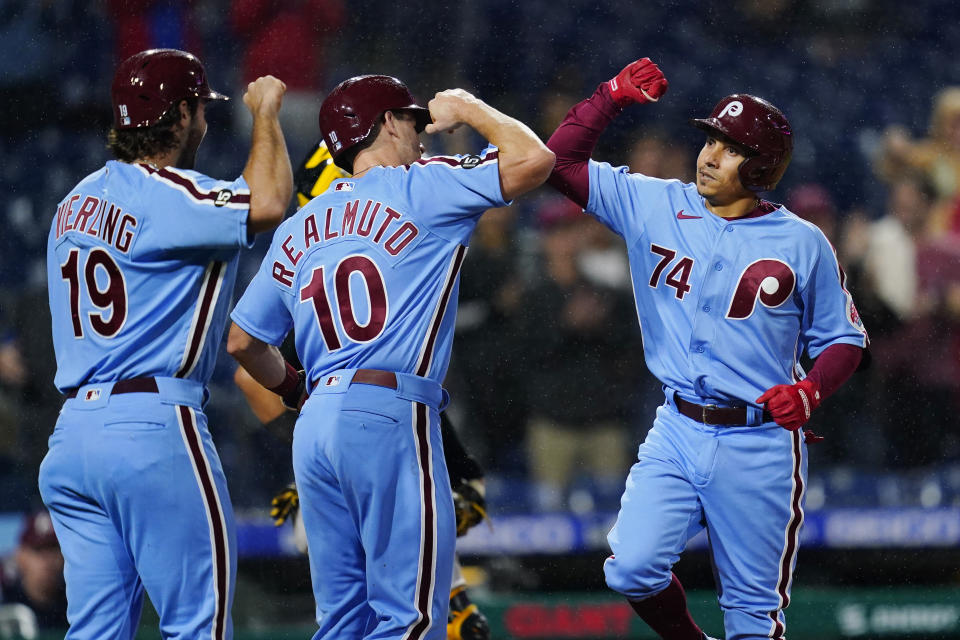 Philadelphia Phillies' Ronald Torreyes, from right, J.T. Realmuto and Matt Vierling celebrate after Torreyes' three-run home run during the sixth inning of a baseball game against the Pittsburgh Pirates, Thursday, Sept. 23, 2021, in Philadelphia. (AP Photo/Matt Slocum)