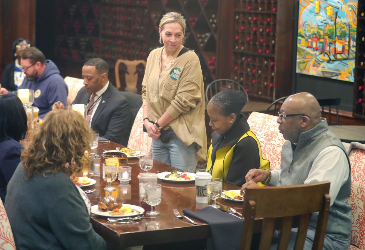 Erika Mayer, a core leadership team member of the LeBron James Family Foundation, introduces herself during a breakfast meeting Monday with members of the Akron School Board at House Three Thirty in Akron.