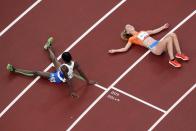 Alex Rose, of Samoa, and Diane Van Es, of Netherlands, colapse after competing during the first round of the women's 5,000-meter at the 2020 Summer Olympics, Friday, July 30, 2021, in Tokyo. (AP Photo/Morry Gash)