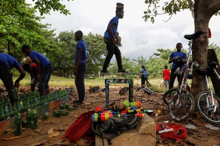 Members of the GKB academy, a unicycle club, prepare for their training session in an open field in Lagos