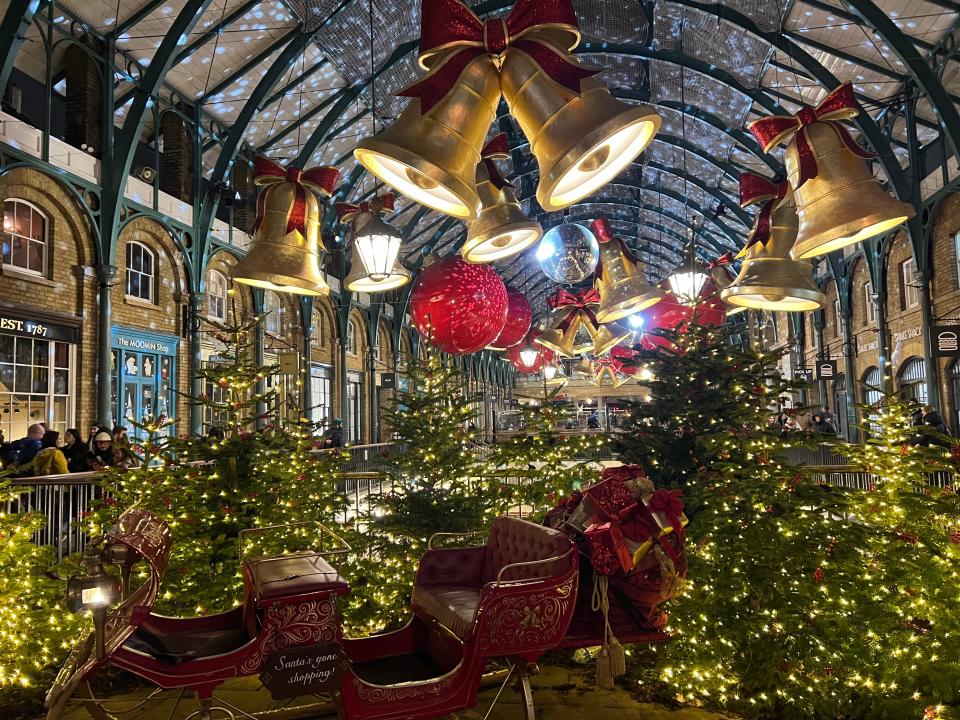 Golden bells and bright baubles decorate the Apple Market in London's Covent Garden neighborhood.