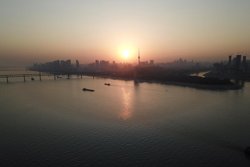 This aerial photo shows Wuhan skyline, China, Thursday evening, Jan. 14, 2021. A global team of researchers arrived Thursday in the Chinese city where the coronavirus pandemic was first detected to conduct a politically sensitive investigation into its origins amid uncertainty about whether Beijing might try to prevent embarrassing discoveries. (AP Photo/Samuel McNeil)