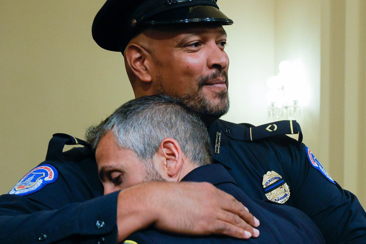 Sgt Harry Dunn hugs officer Michael Fanone after the House select committee hearing (AP)