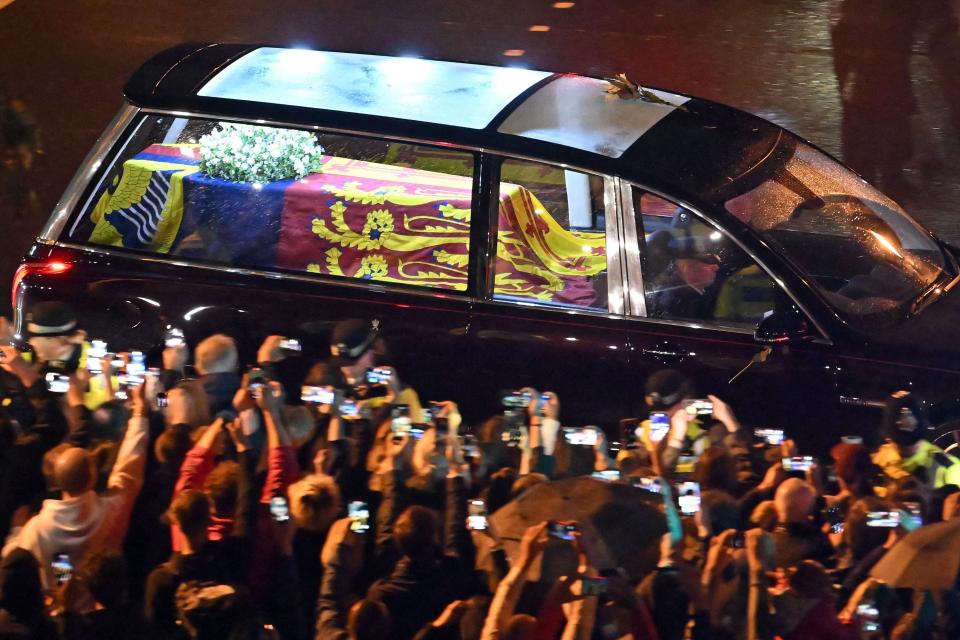 Seen from the top of the Wellington Arch, the coffin of Queen Elizabeth II is taken in the Royal Hearse to Buckingham Palace in London on Sept. 13, 2022, as thousands on the street watch.