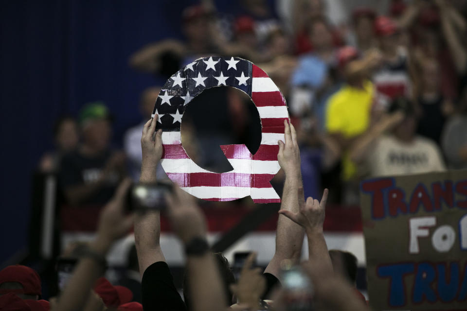 An attendee holds signs a sign of the letter &quot;Q&quot; before the start of a rally with U.S. President Donald Trump in Lewis Center, Ohio, U.S., on Saturday, Aug. 4, 2018. (Maddie McGarvey/Bloomberg via Getty Images)