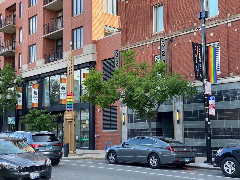 a street in boystown chicago with rainbow flags