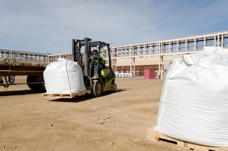 A forklift operator arranges 1,500 kg bags of bastnasite concentrate for shipping at the MP Materials rare earth mine in Mountain Pass