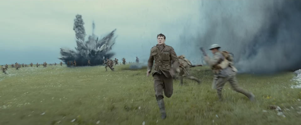 a soldier runs away as bombs explode